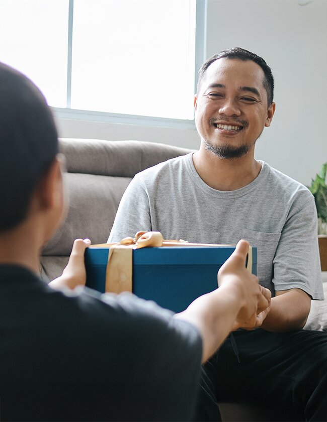 Image of Father Receiving Gift From Son